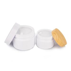China 120ml Cylindrical Plastic Cream Jar With Bamboo Lid Opaque White Body on sale