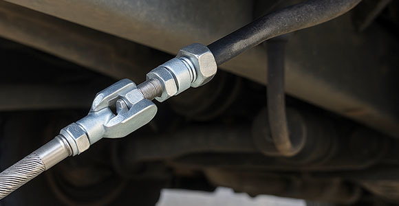 Stainless steel pull-only control cable installed in a commercial vehicle gear shift linkage under chassis